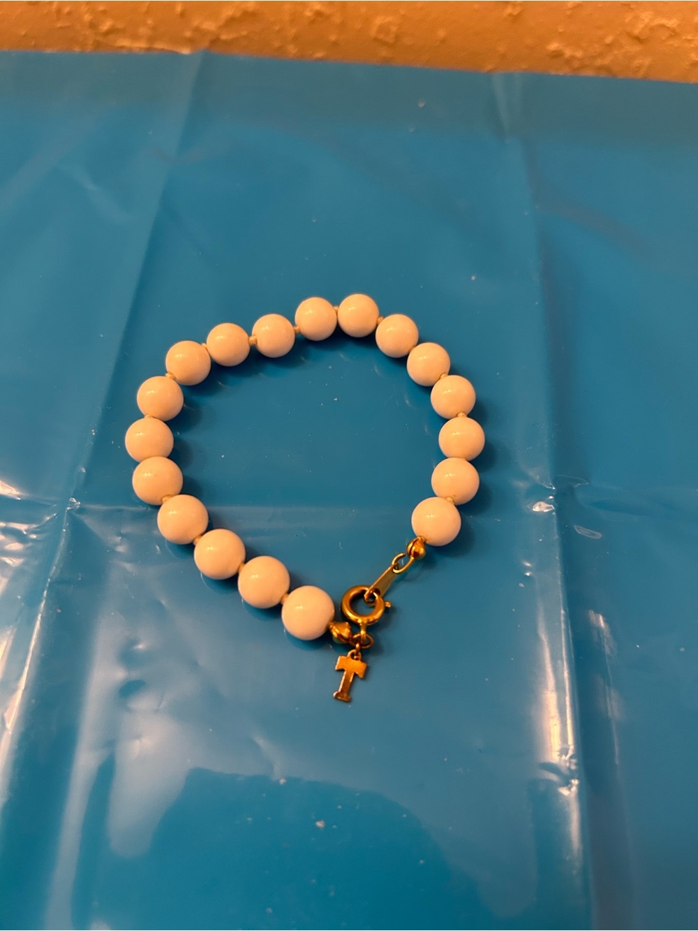 Vintage Trifari White Beaded Bracelet with Gold Trifari T logo Charm
